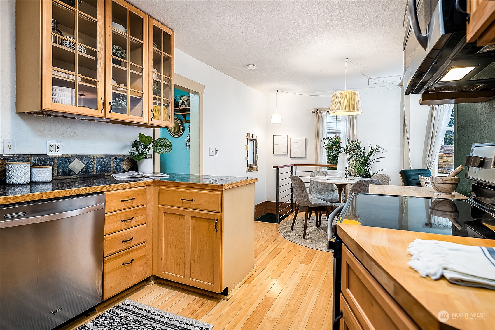 4100 Southwest Raymond Street Seattle, WA 98136 - Photo 10 of 23 a kitchen with stainless steel appliances granite countertop a stove a sink and a refrigerator