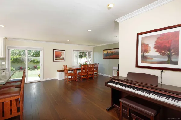 a living room with furniture and a piano