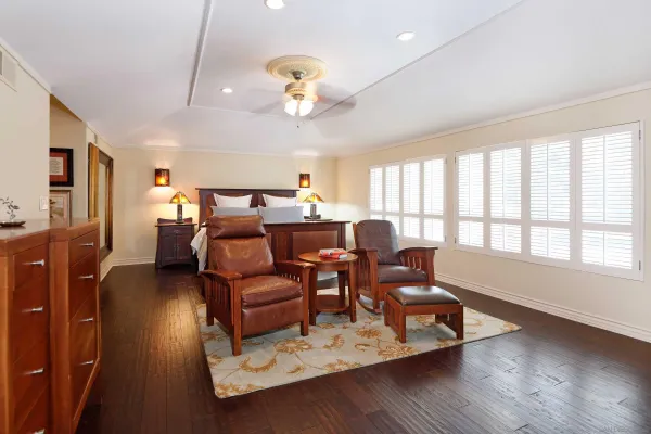 a view of a dining room with furniture a chandelier and wooden floor