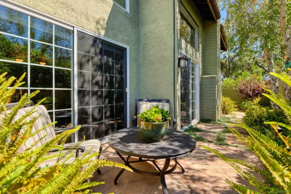 a backyard of a house with table and chairs