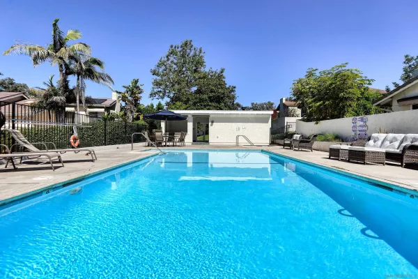 a swimming pool with trees in the background