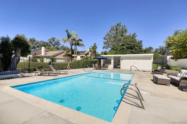 a view of a swimming pool with lounge chairs