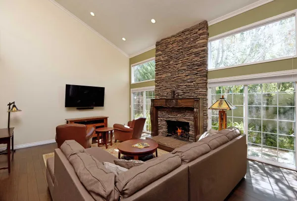 a living room with furniture a flat screen tv and a fireplace