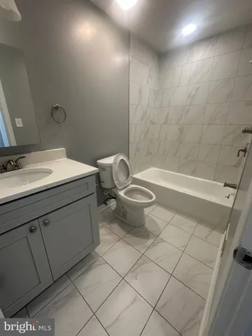 a bathroom with a sink a toilet and a bathtub