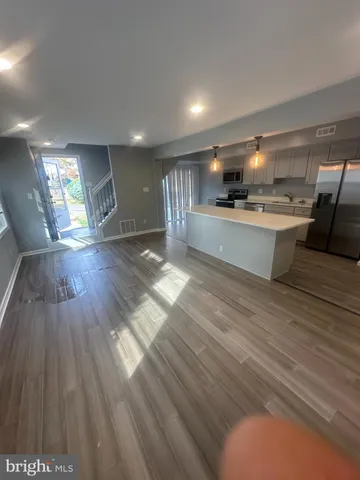 a large white kitchen with cabinets a sink and a dishwasher