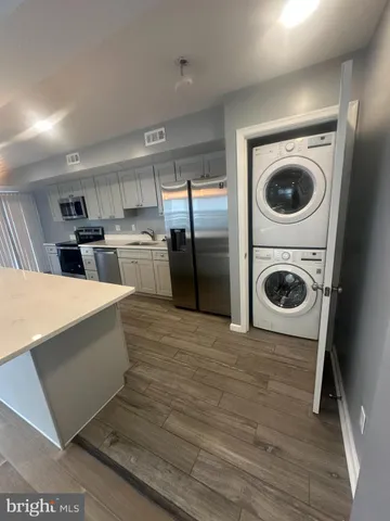 a kitchen with a refrigerator sink and cabinets