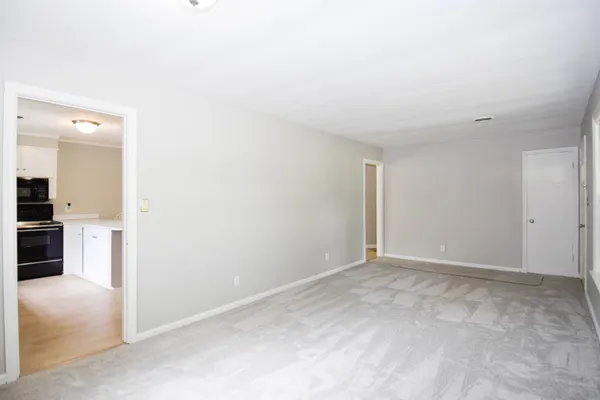 an empty room with a kitchen