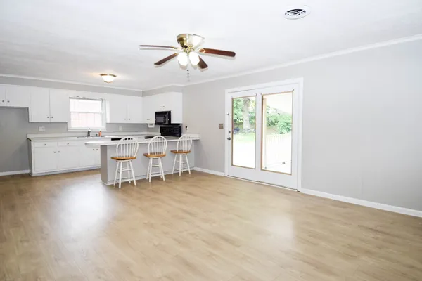 a view of a kitchen with a sink cabinets and wooden floor