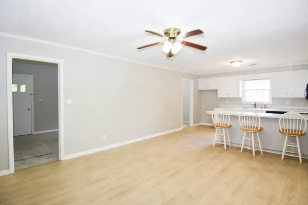 a view of a kitchen with furniture and a fan
