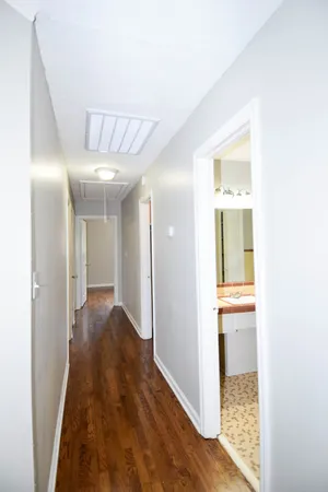 a view of a hallway with wooden floor