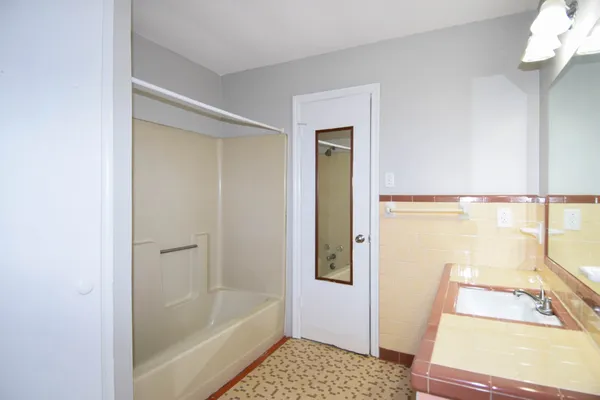 a bathroom with a tub and a shower