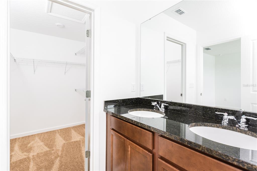 987 Spring Palms Loop Orlando, FL 32828 - Photo 12 of 22 a bathroom with a granite countertop sink and a mirror