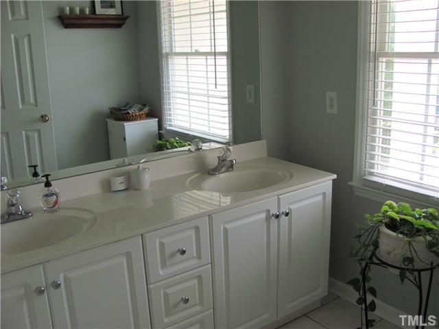 12224 Breton Lane Raleigh, NC 27613 - Photo 17 of 25 a bathroom with a sink and a vanity