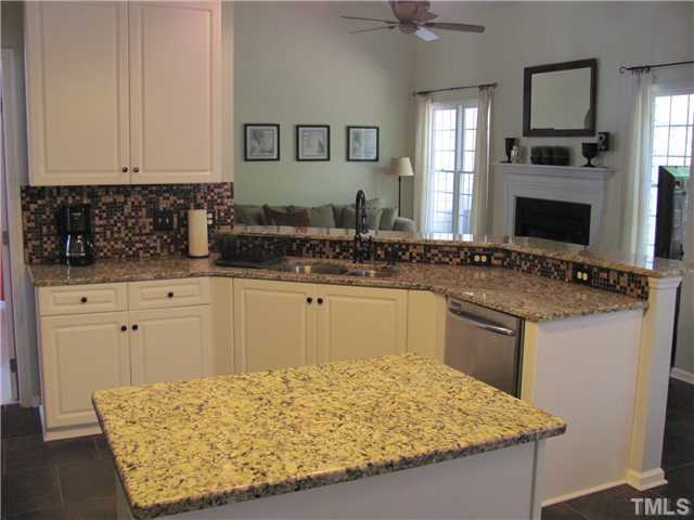 12224 Breton Lane Raleigh, NC 27613 - Photo 9 of 25 a kitchen with a sink refrigerator and cabinets