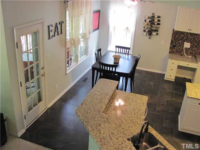 12224 Breton Lane Raleigh, NC 27613 - Photo 10 of 25 a dining room with furniture and wooden floor