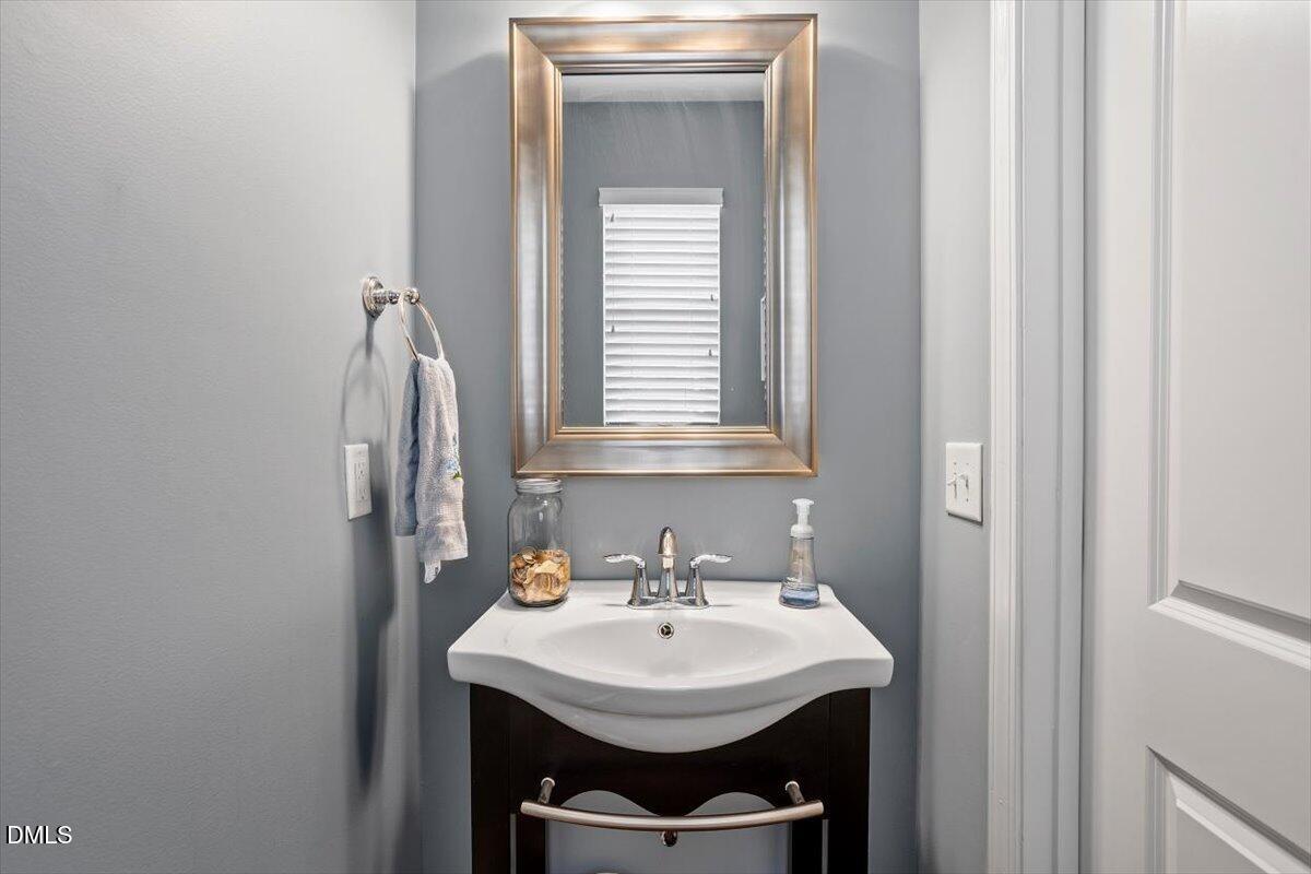 1427 Crafton Way Raleigh, NC 27607 - Photo 11 of 26 a bathroom with a sink and a mirror