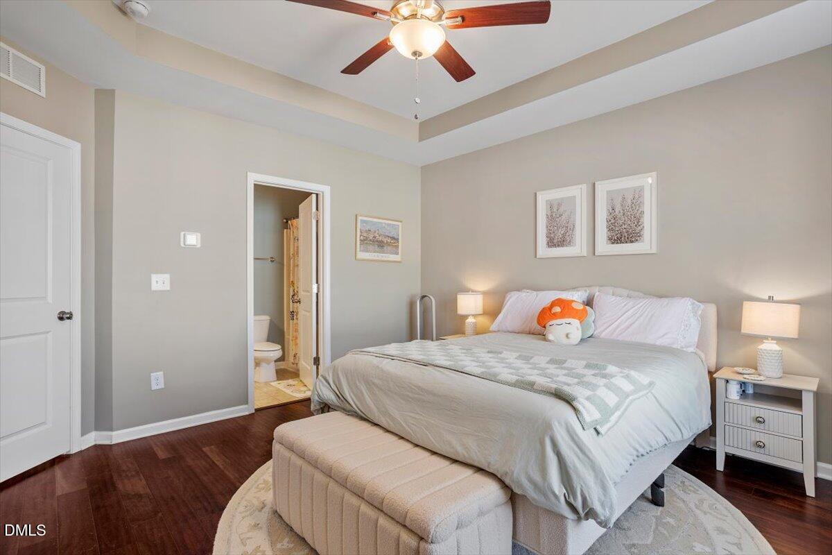 1427 Crafton Way Raleigh, NC 27607 - Photo 13 of 26 a bedroom with a bed and a chandelier