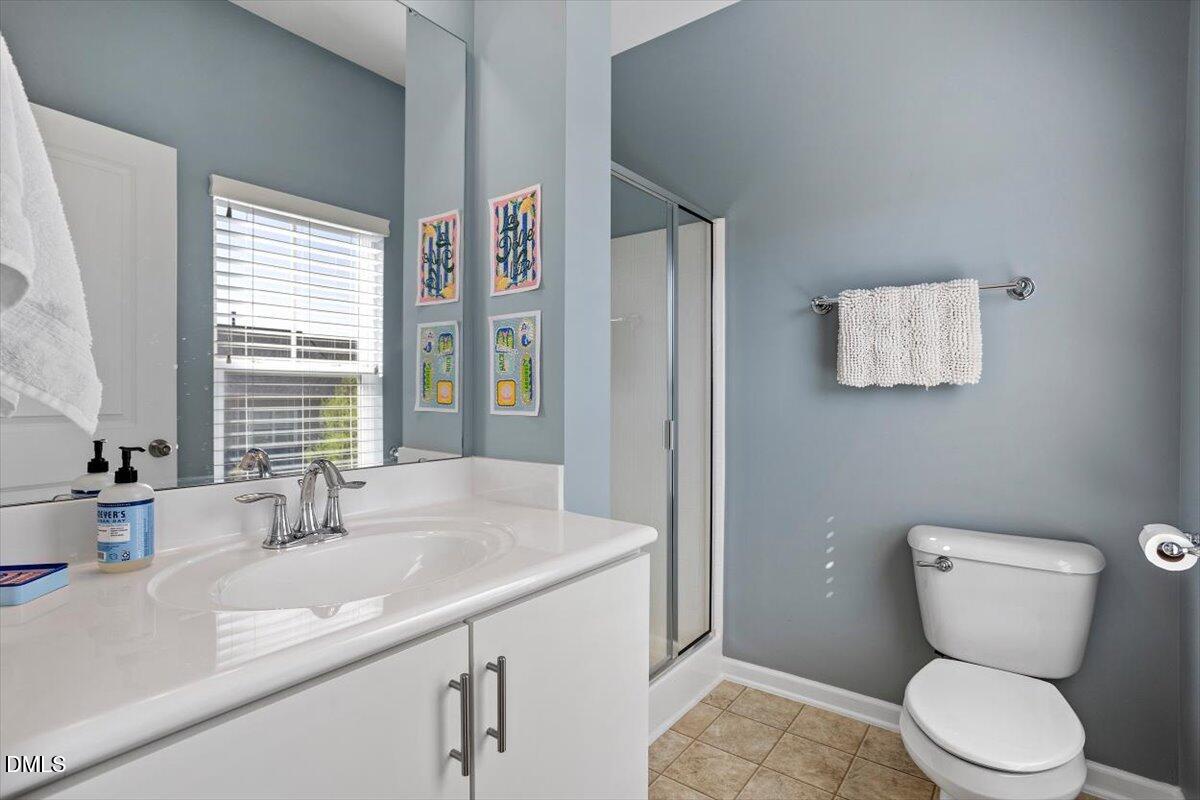 1427 Crafton Way Raleigh, NC 27607 - Photo 18 of 26 a bathroom with a granite countertop toilet sink and mirror