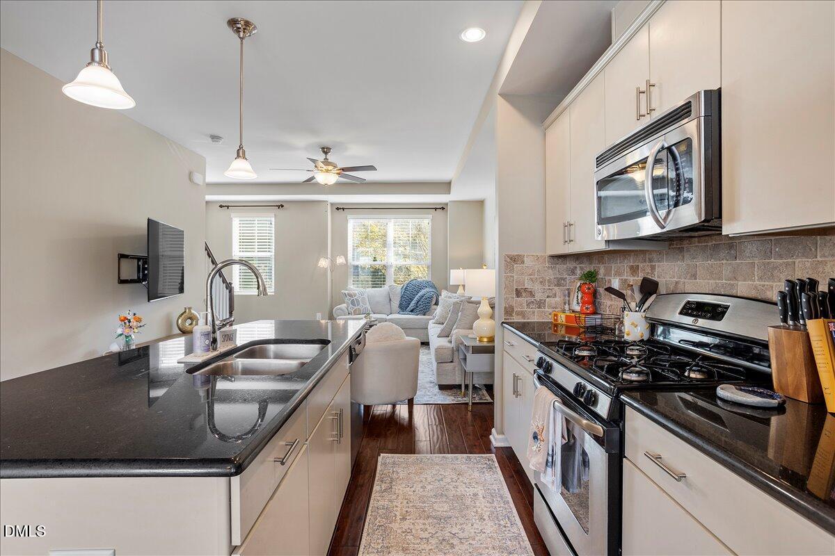 1427 Crafton Way Raleigh, NC 27607 - Photo 9 of 26 a kitchen that has a sink a stove and a table