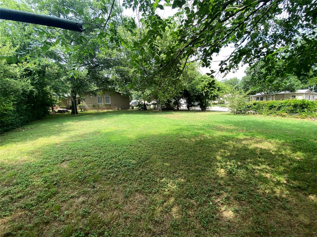 425 Wanda Way Hurst, TX 76053 - Photo 7 of 10 Expansive grassy yard with mature trees providing partial shade