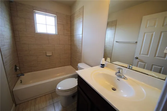 a bathroom with a sink toilet tub and shower