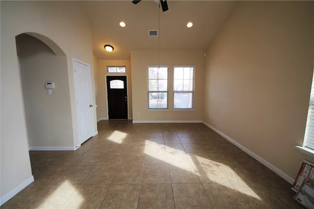 a view of a hallway with wooden shelves