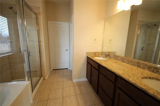 a bathroom with a granite countertop sink a toilet and shower