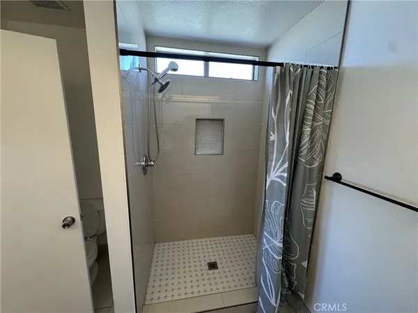 a bathroom with a glass shower door and a sink