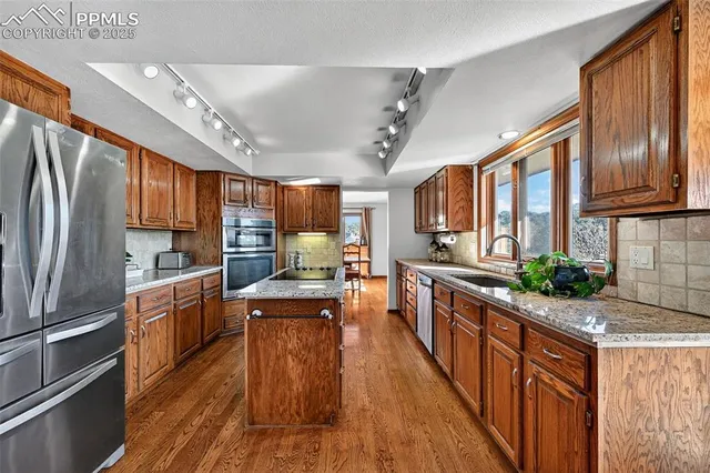 a kitchen with stainless steel appliances granite countertop lots of counter top space