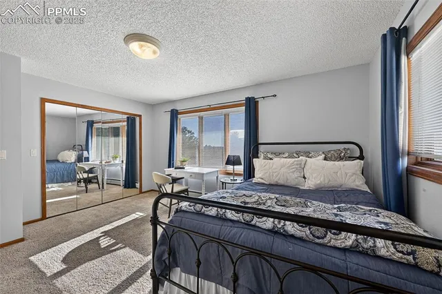 a bedroom with a bed and glass windows