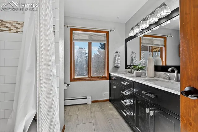 a spacious bathroom with a double vanity sink a mirror and a
