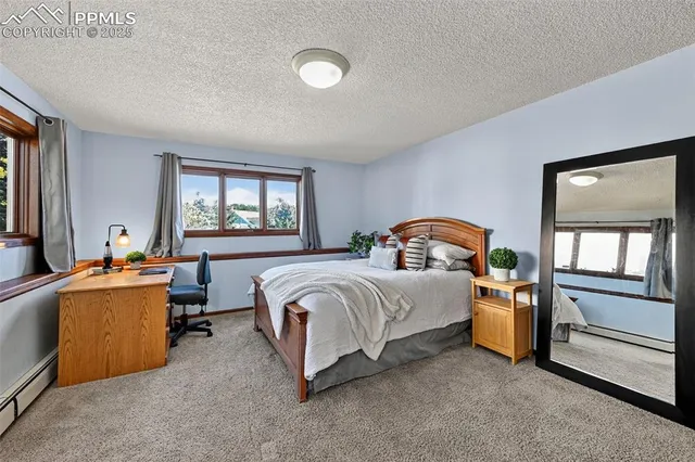 a bedroom with a bed and a large window