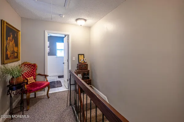 a view of a livingroom with furniture and staircase