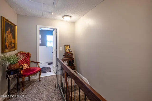 a view of a livingroom with furniture and staircase
