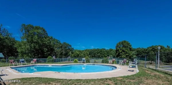 a view of a swimming pool with a yard