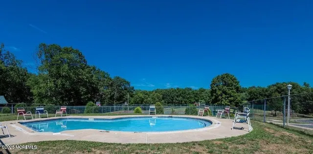 a view of a swimming pool with a yard