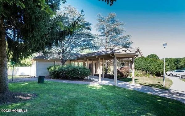 a view of a patio with table and chairs under an umbrella
