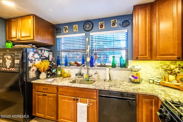 a kitchen with stainless steel appliances granite countertop sink and a window