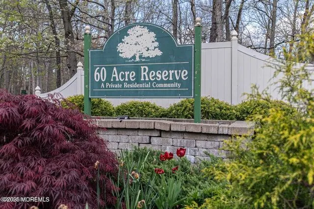a view of sign board and buildings in the background