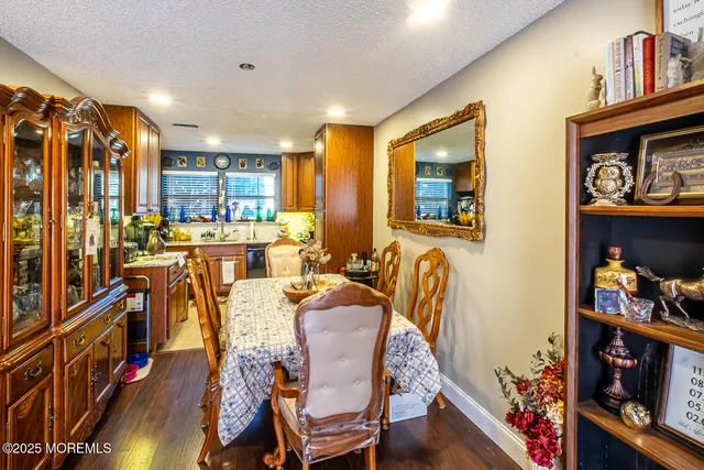 a view of a dining room with furniture and a book shelf