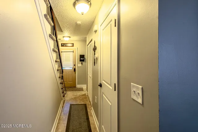 a view of a hallway with a door