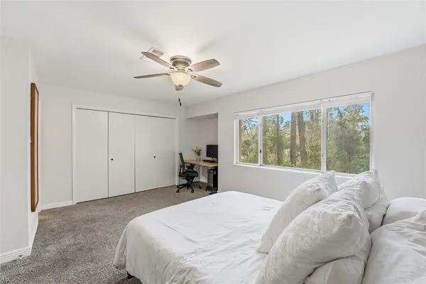 a bed room with a bed and a window