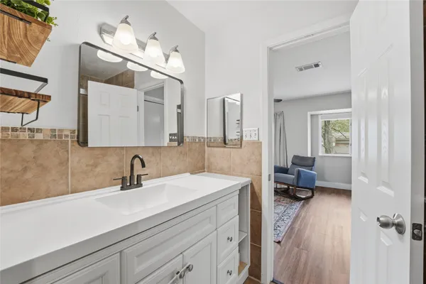 a en suite bathroom with a double vanity sink a mirror and shower
