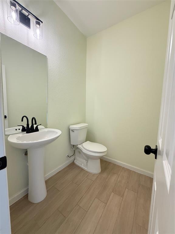 2864 Burchill Road Fort Worth, TX 76105 - Photo 14 of 26 a white toilet sitting next to a bathroom sink