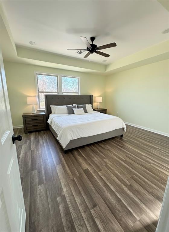 2864 Burchill Road Fort Worth, TX 76105 - Photo 21 of 26 a bedroom with a bed and wooden floor