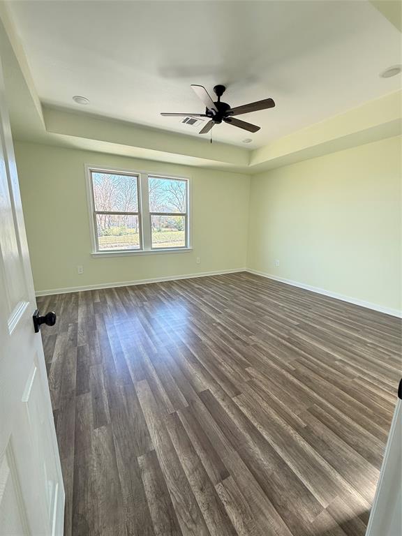 2864 Burchill Road Fort Worth, TX 76105 - Photo 7 of 26 a view of an empty room with wooden floor and a window