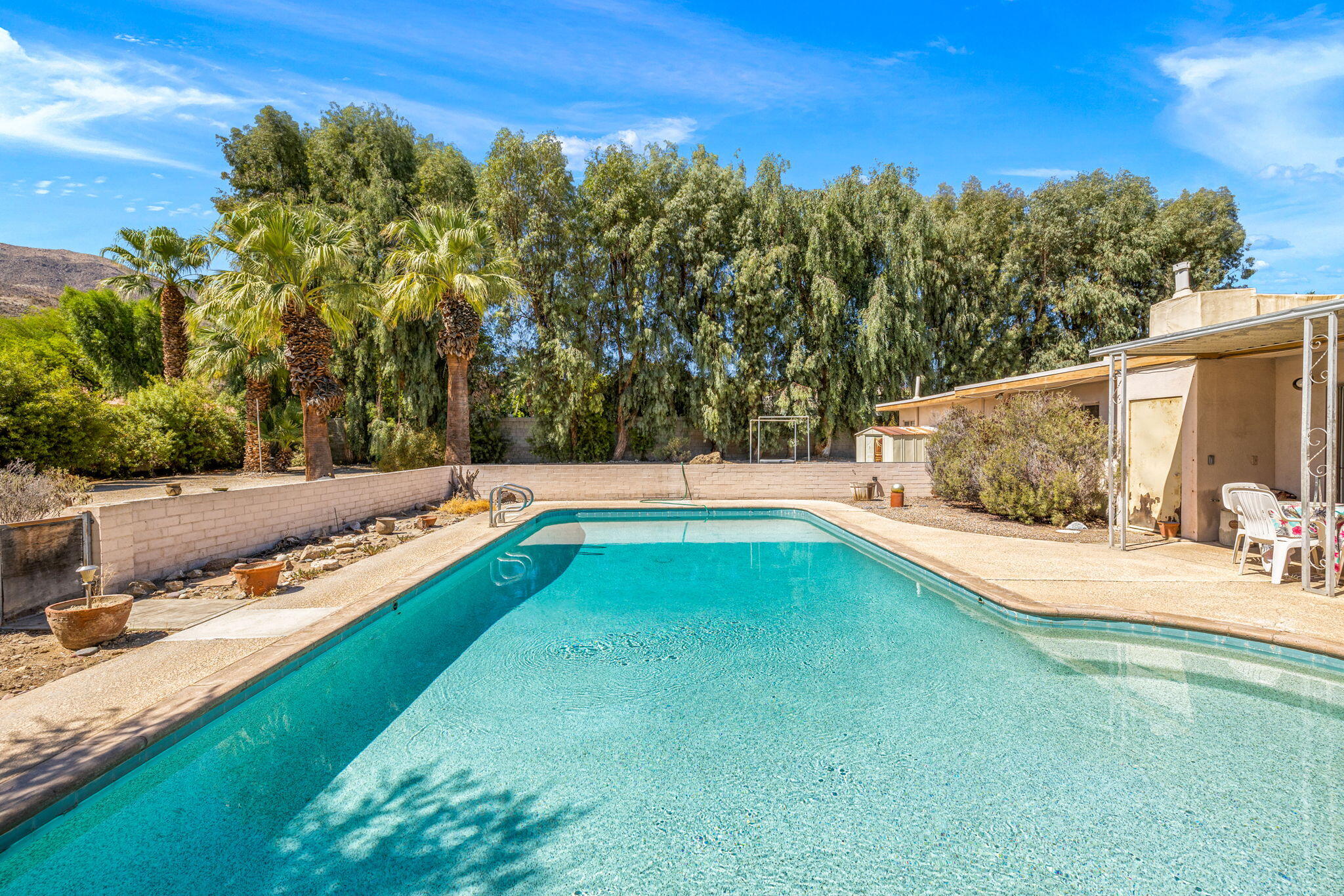 72227 Rancho Road Rancho Mirage, CA 92270 - Photo 18 of 47 a view of a backyard with a large pool and sitting area