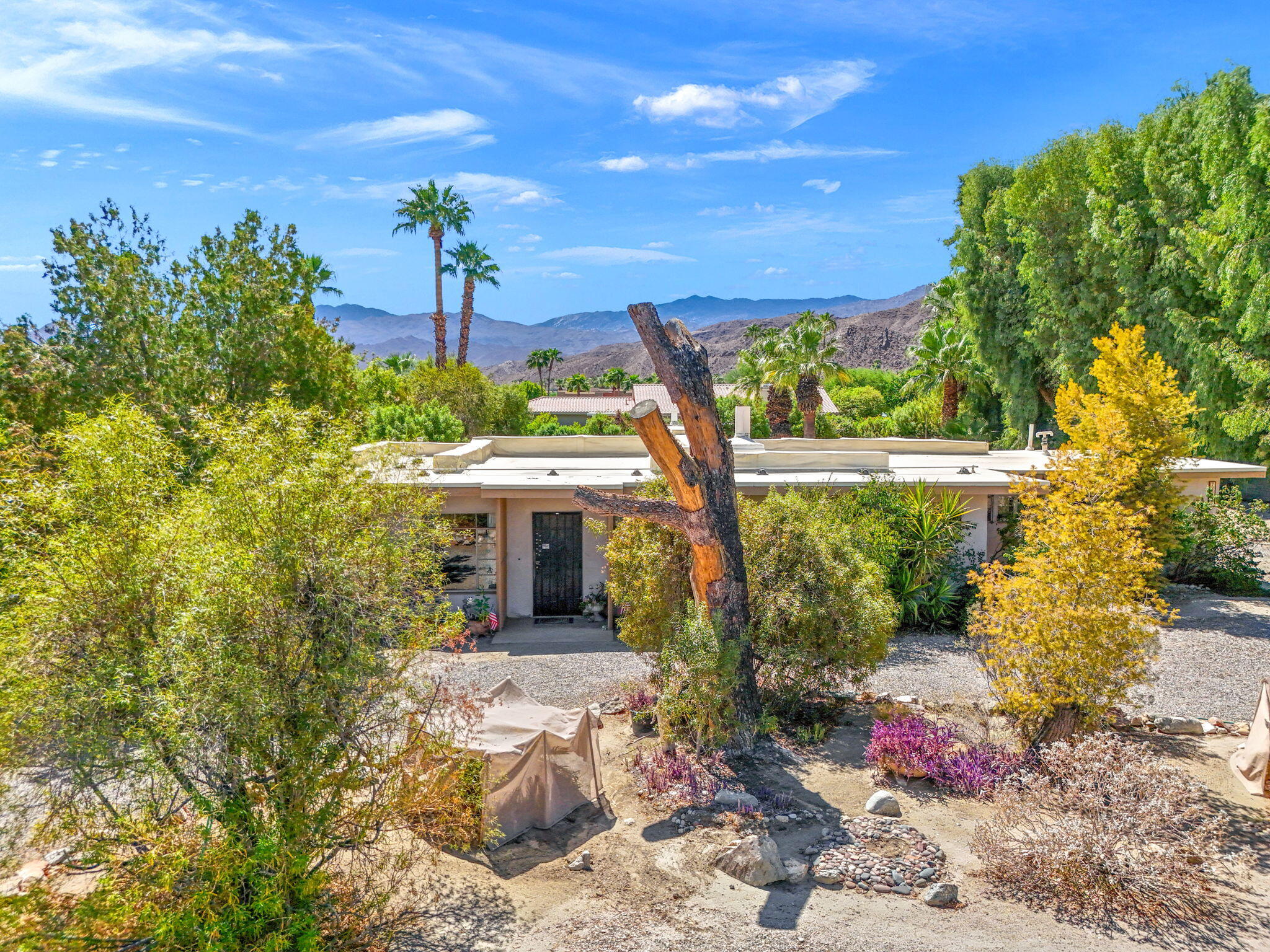 72227 Rancho Road Rancho Mirage, CA 92270 - Photo 10 of 47 a view of a patio with table and chairs and potted plants
