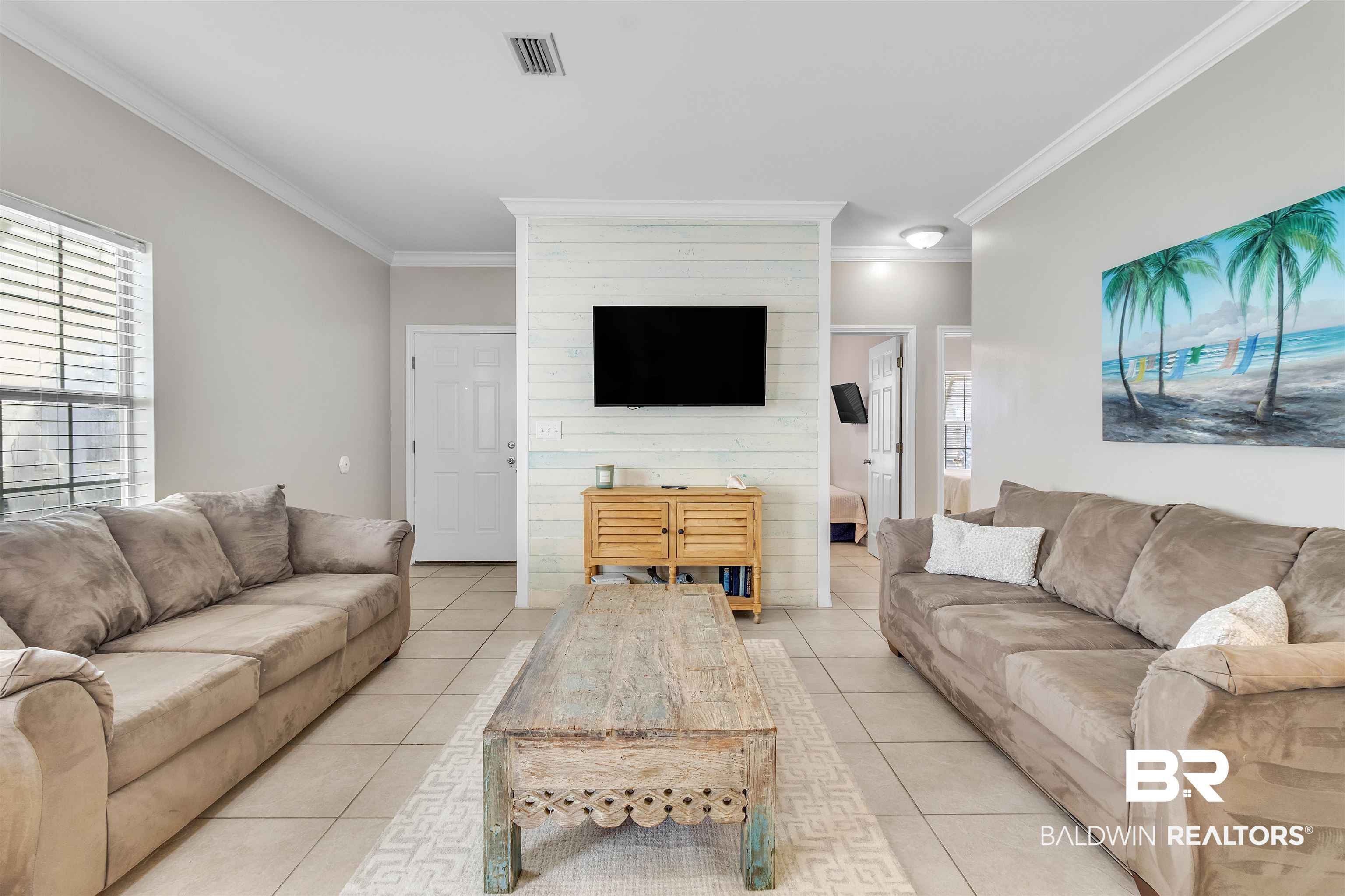 4324 B Lindsey Lane, Unit 4324B Orange Beach, AL 36561 - Photo 6 of 33 Living area with light tile patterned floors, plenty of natural light, visible vents, and ornamental molding