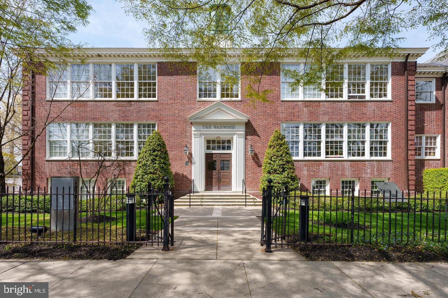 35 Quarry Street, Unit 104 Princeton, NJ 08542 - Photo 12 of 12 front view of a brick house with a small yard